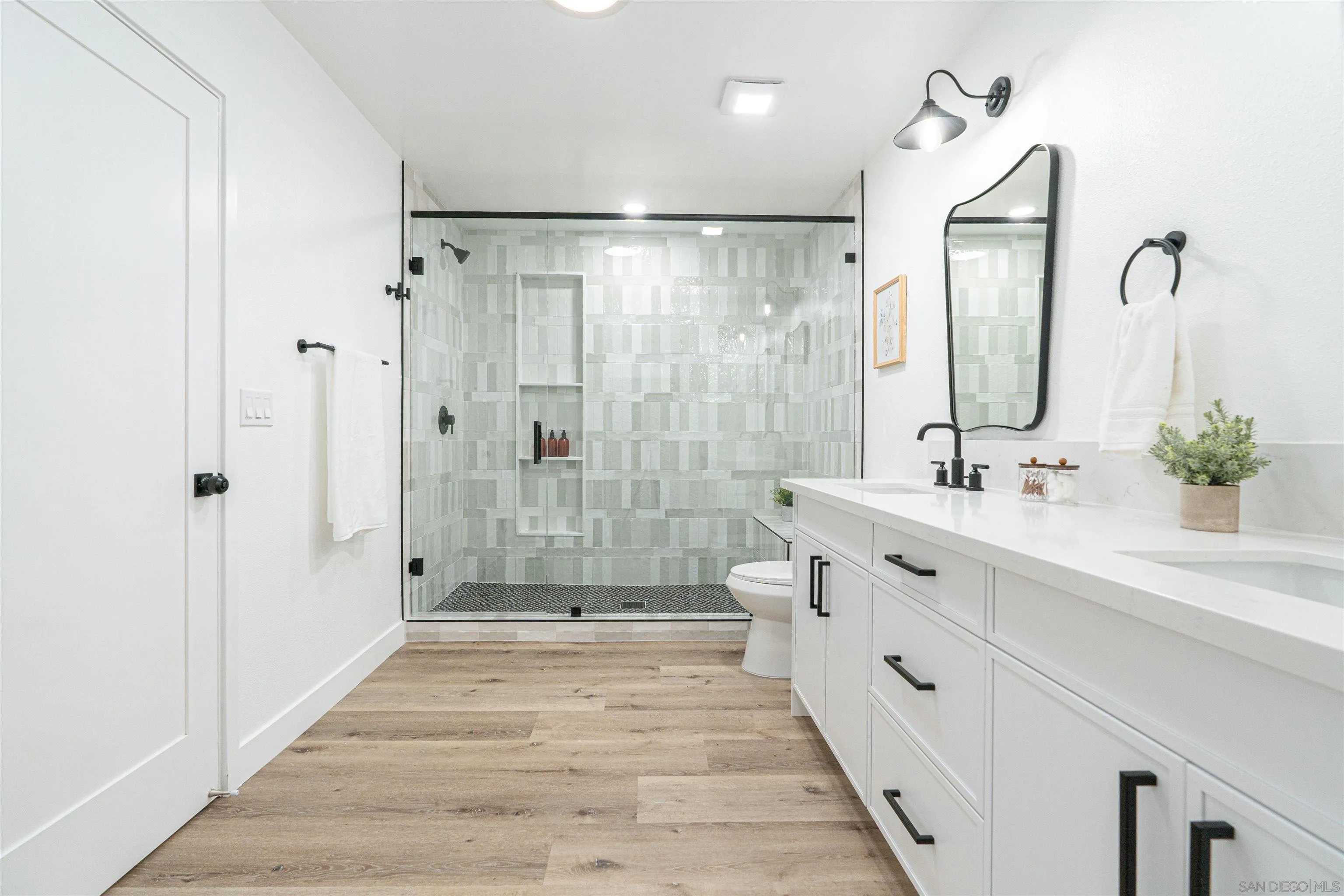9376 Starcrest Drive Santee, CA 92071 - Photo 23 of 39 a bathroom with a double vanity sink mirror double and shower