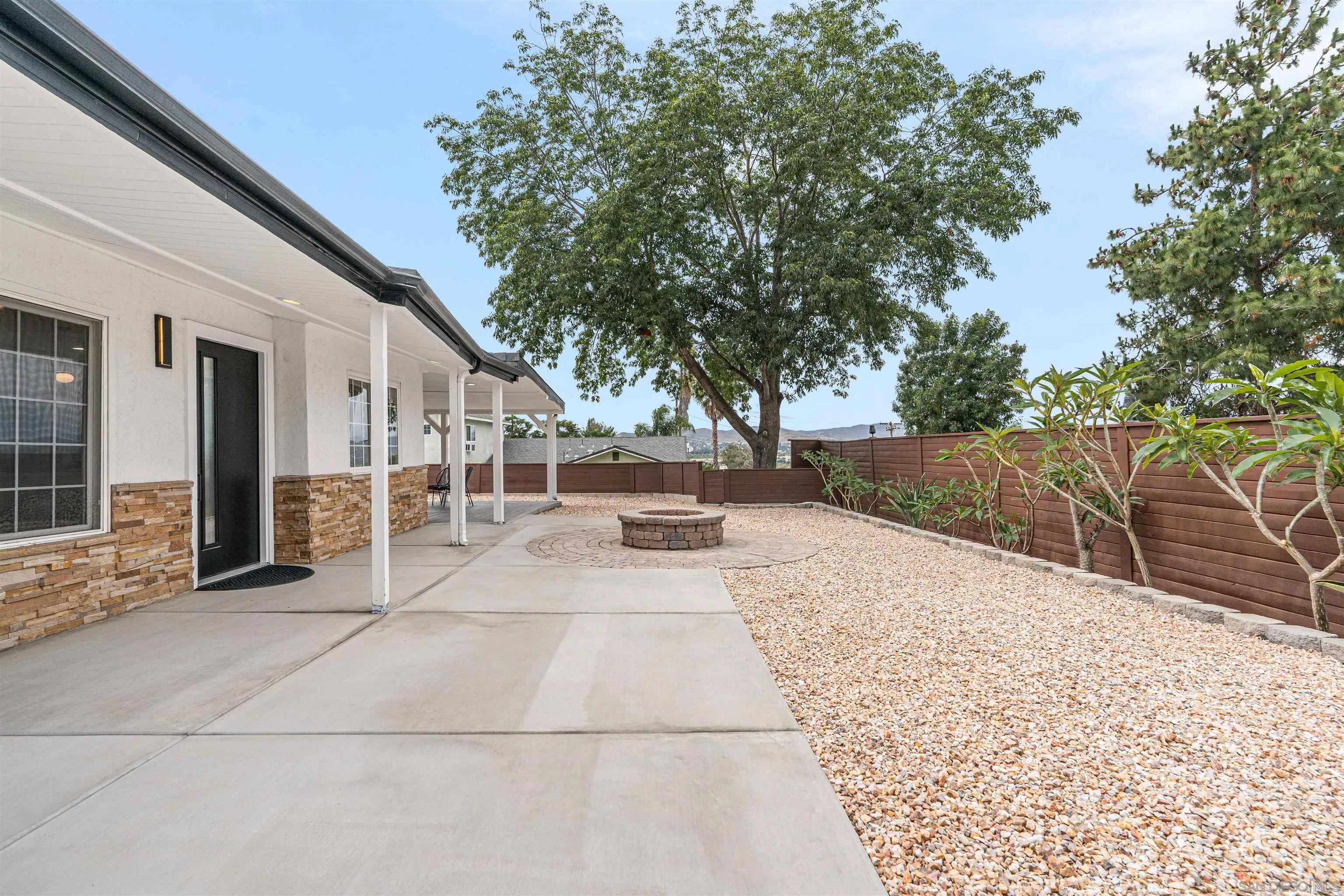 9376 Starcrest Drive Santee, CA 92071 - Photo 30 of 39 a view of backyard with large trees and flower plants