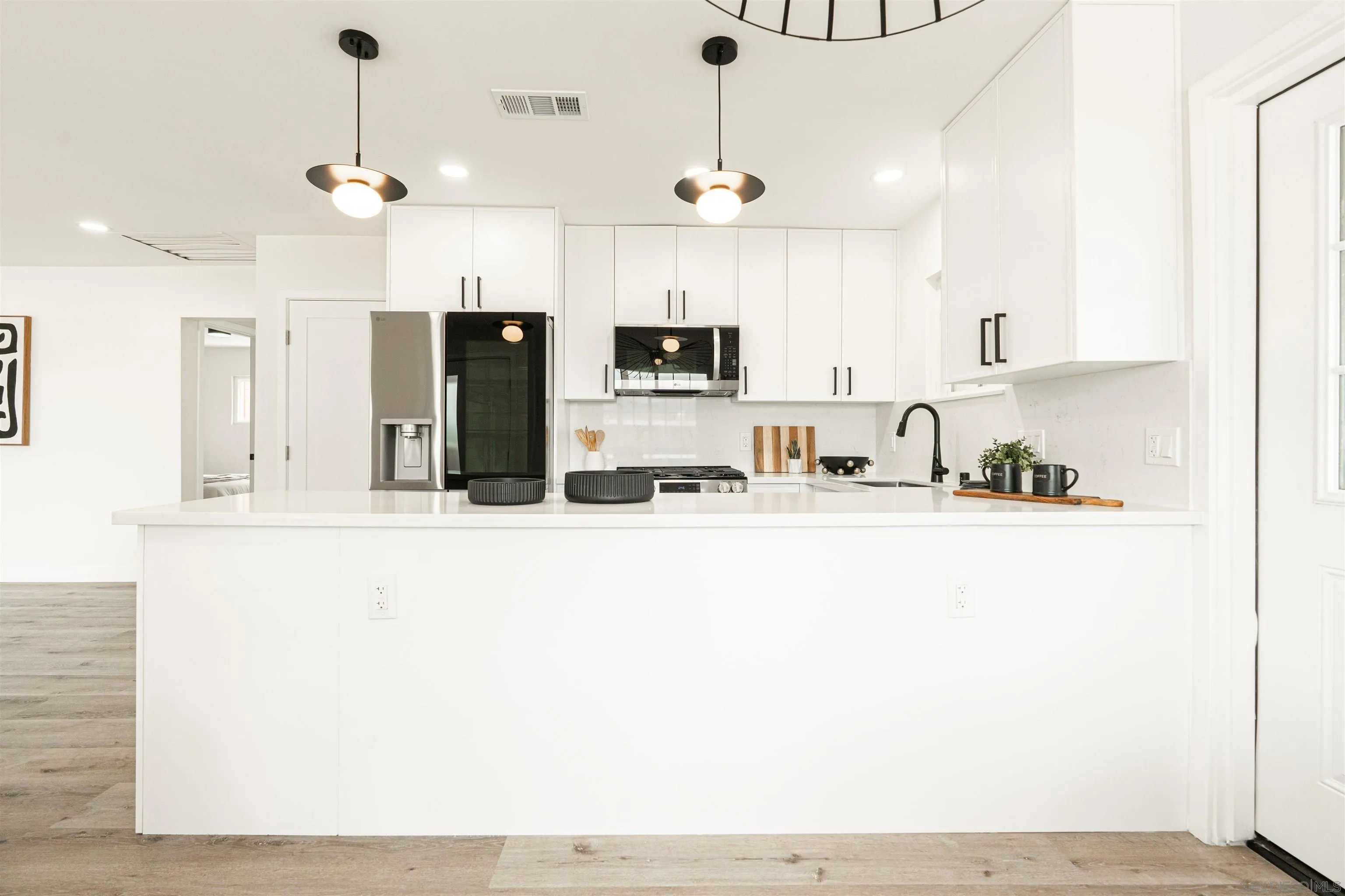 9376 Starcrest Drive Santee, CA 92071 - Photo 3 of 39 a view of a kitchen with kitchen island a sink stainless steel appliances and cabinets