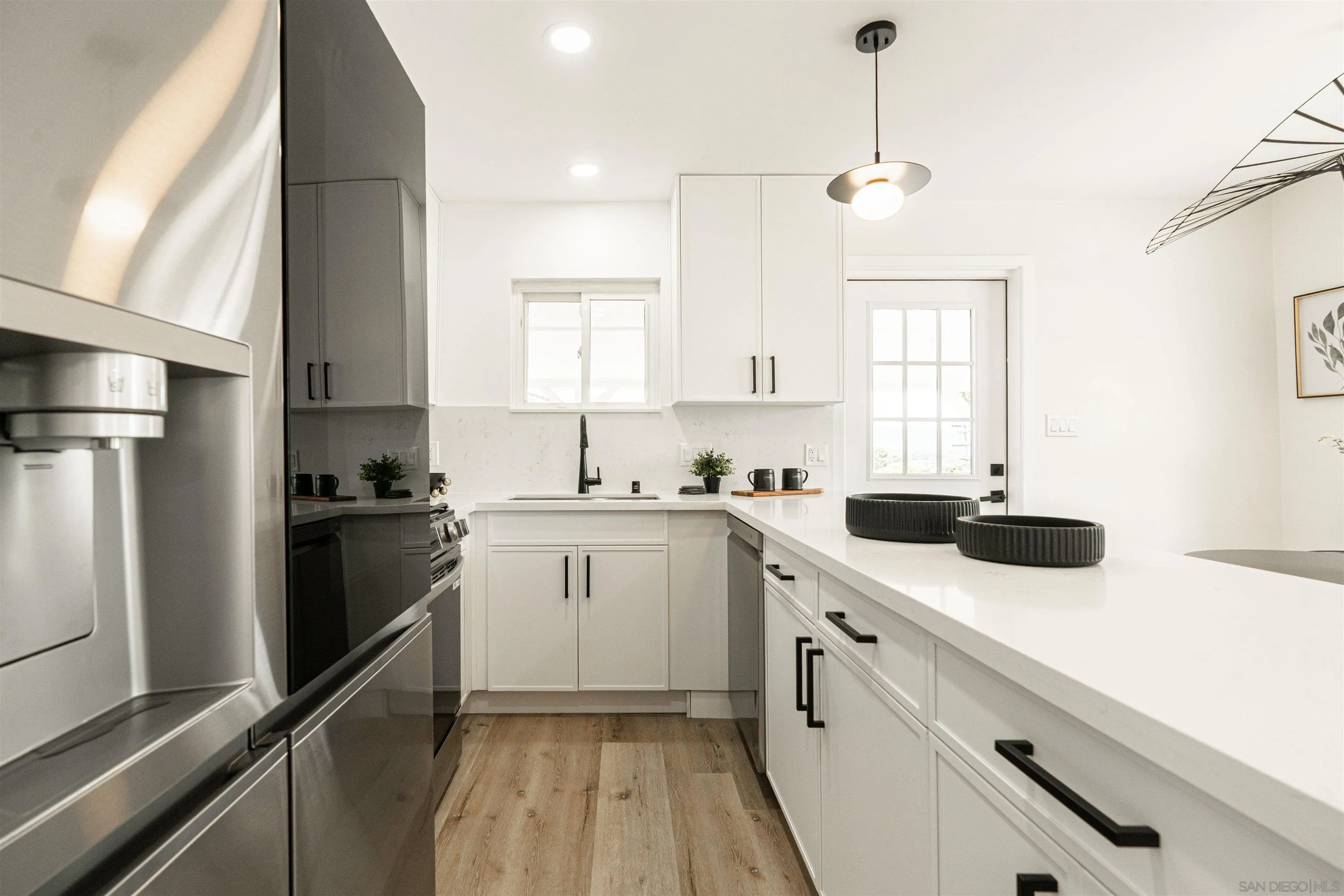 9376 Starcrest Drive Santee, CA 92071 - Photo 5 of 39 a kitchen with a sink dishwasher a refrigerator and cabinets