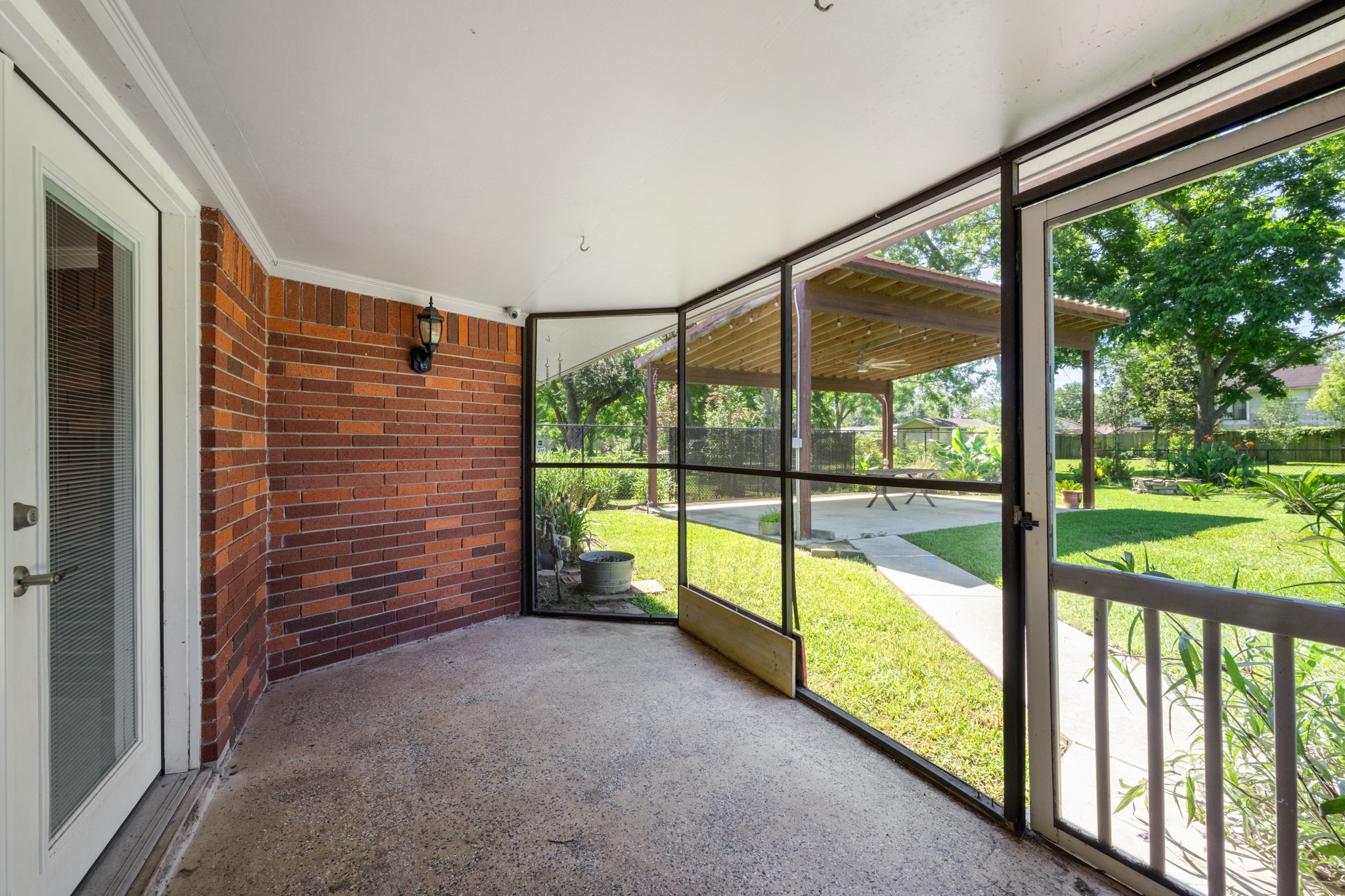 616 Cannan Drive Angleton, TX 77515 - Photo 26 of 49 Enjoy the outdoors in comfort from this screened porch, offering a shaded space to relax while overlooking the backyard. With easy access to the patio and lawn beyond, it's an ideal spot for morning coffee, evening conversations, or year-round outdoor enjoyment.