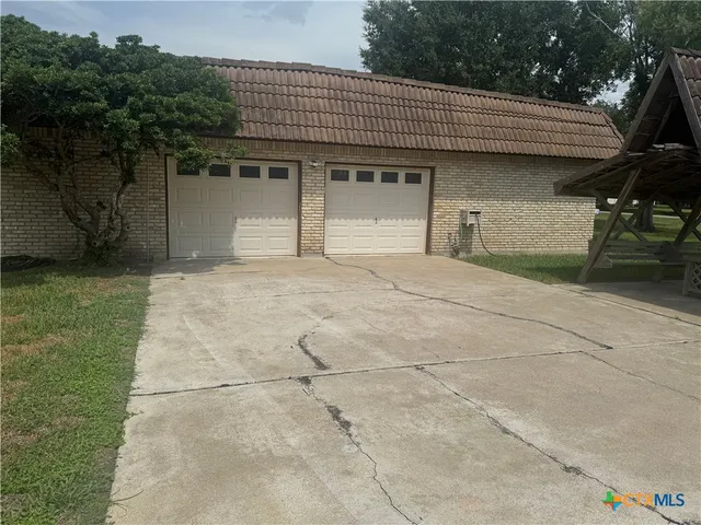 a view of an empty room with closet and a window