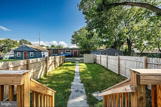 a view of a house with large trees