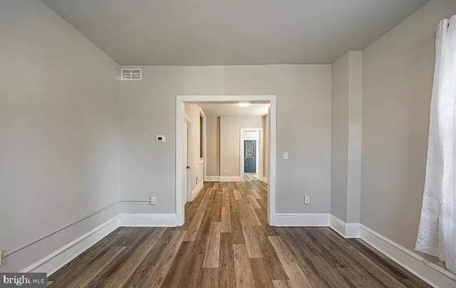a view of a room with wooden floor and closet