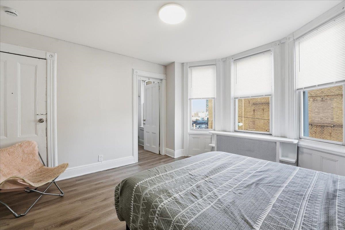 335 47th Street, Unit 3 Union City, NJ 07087 - Photo 11 of 14 a bedroom with a bed and chair