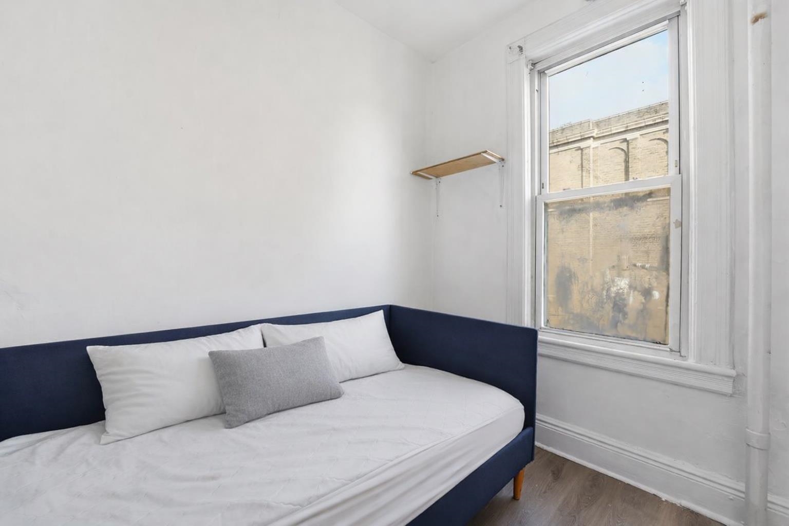 335 47th Street, Unit 3 Union City, NJ 07087 - Photo 12 of 14 a bedroom with a large bed and a window