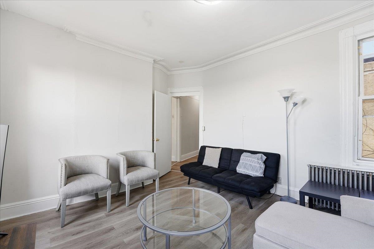 335 47th Street, Unit 3 Union City, NJ 07087 - Photo 3 of 14 a living room with furniture and a wooden floor