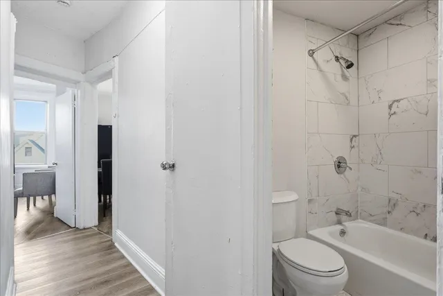 a bathroom with a bathtub toilet and a shower