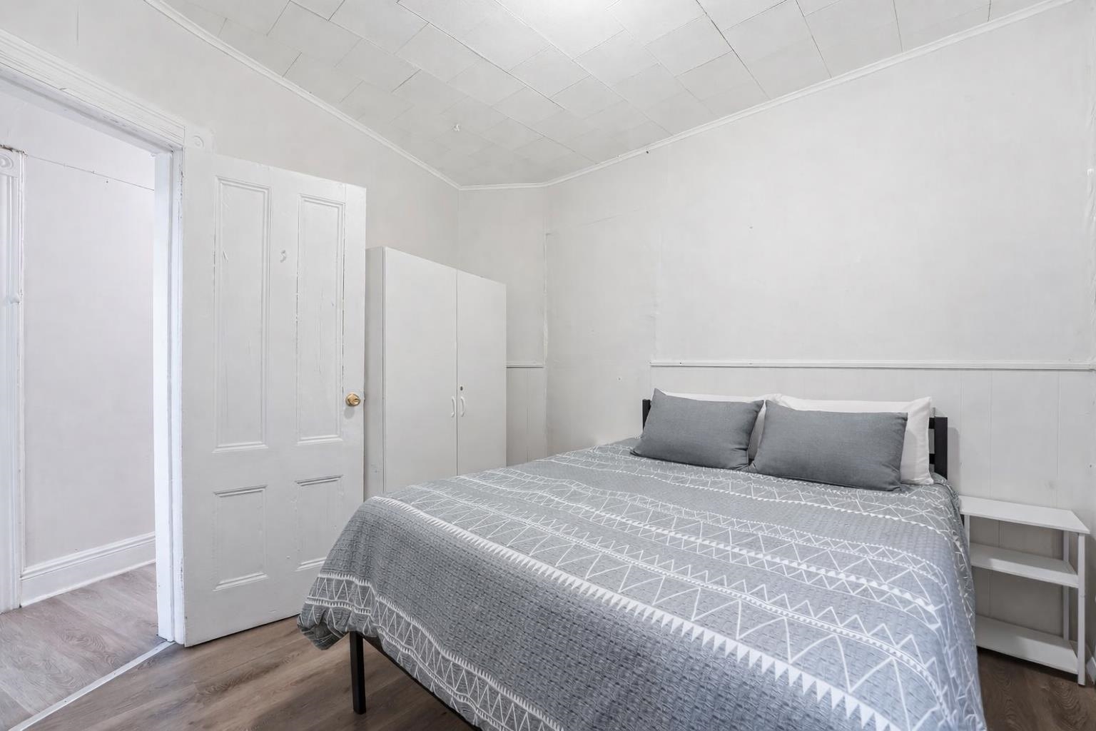 335 47th Street, Unit 3 Union City, NJ 07087 - Photo 7 of 14 a bedroom with a bed and wooden floor