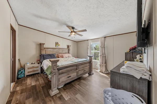 a bed room with a bed window and a television