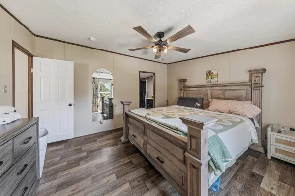 a bedroom with a bed and a chandelier