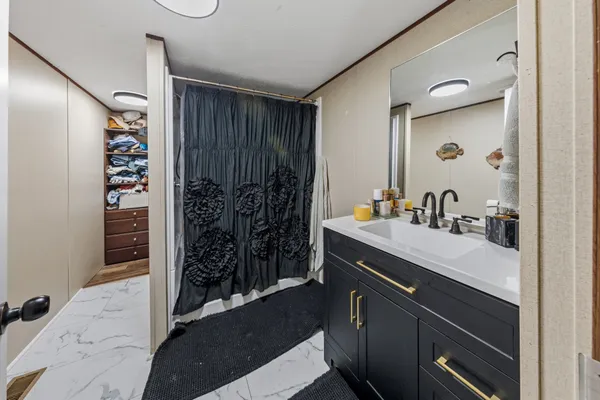 a bathroom with a double vanity sink mirror and shower