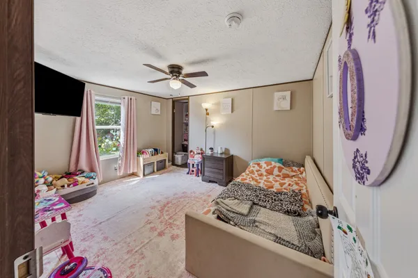 a bedroom with furniture and a window