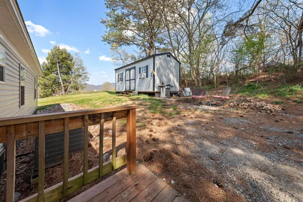a view of a house with backyard and trees