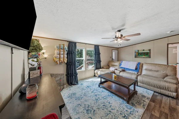 a living room with furniture and wooden floor