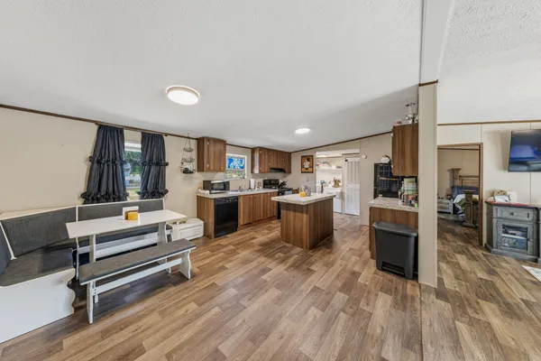a living room with furniture and a kitchen view
