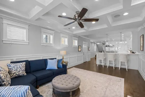 a living room with furniture and a view of kitchen