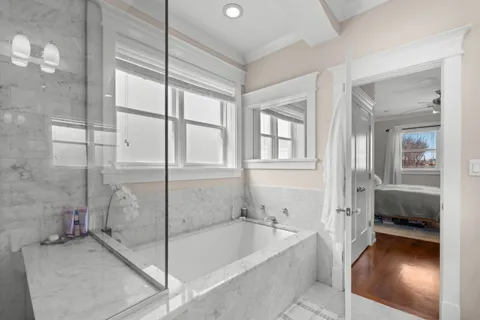 a bathroom with a tub and a shower