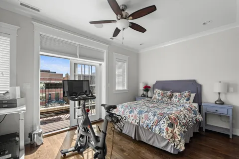 a bedroom with a bed flat screen tv and a window