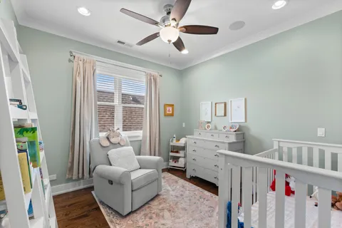 a living room with furniture and baby crib