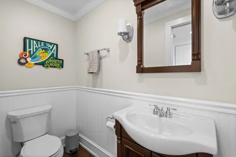 a bathroom with a sink mirror and toilet