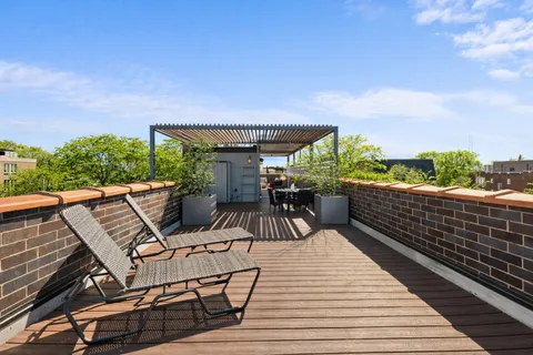 a view of a patio with dining table and chairs with wooden floor