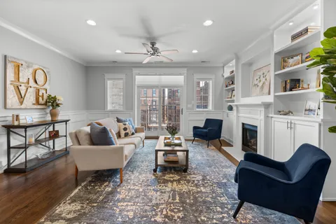 a living room with fireplace furniture and a wooden floor