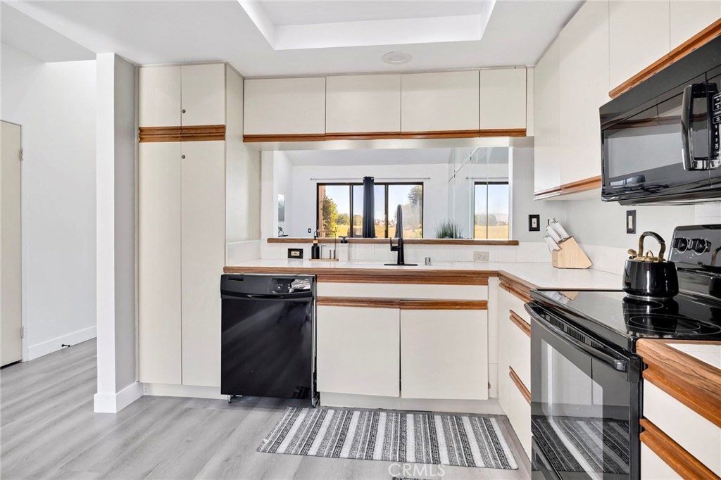 54880 Inverness Way La Quinta, CA 92253 - Photo 14 of 35 a kitchen with a refrigerator and a sink