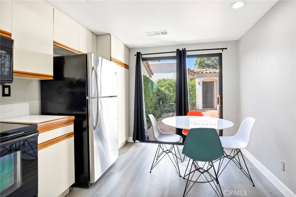 54880 Inverness Way La Quinta, CA 92253 - Photo 15 of 35 a dining room with furniture a fireplace and wooden floor
