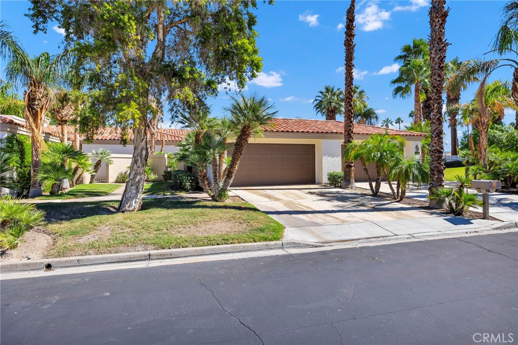 54880 Inverness Way La Quinta, CA 92253 - Photo 2 of 35 a house with palm trees in front of it