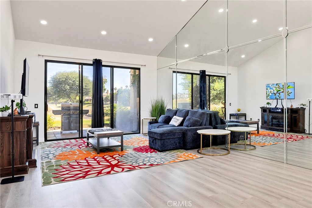 54880 Inverness Way La Quinta, CA 92253 - Photo 8 of 35 a living room with furniture a large window and wooden floor