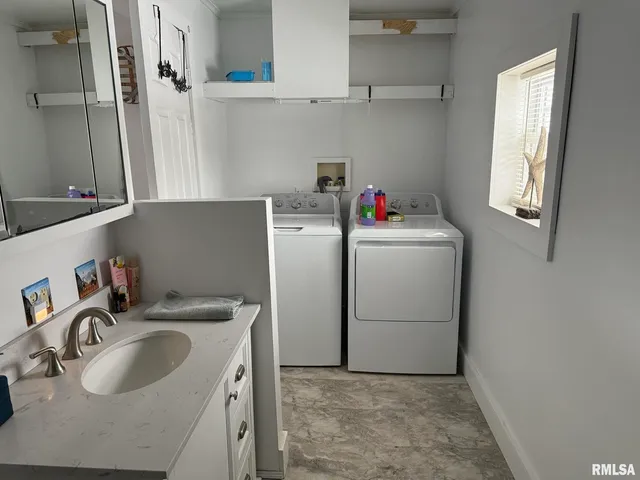 a utility room with sink dryer and washer