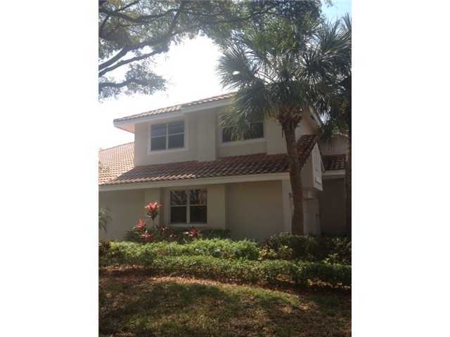2186 Northwest 52nd Street Boca Raton, FL 33496 - Photo 1 of 23 a front view of a house with garden