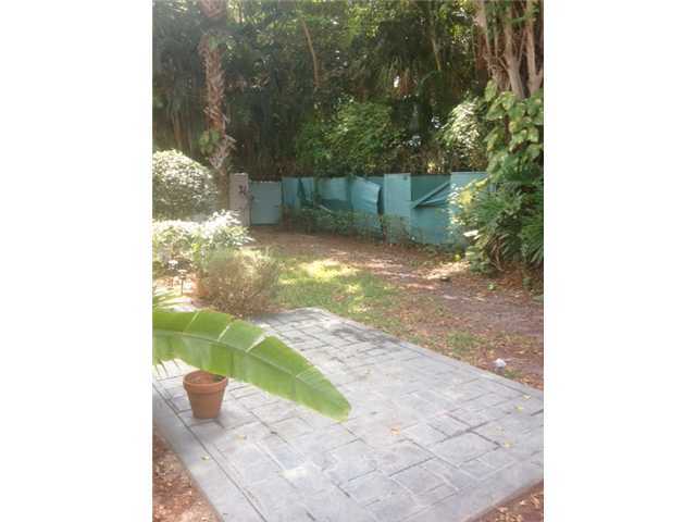 2186 Northwest 52nd Street Boca Raton, FL 33496 - Photo 3 of 23 a backyard of a house with large trees and plants