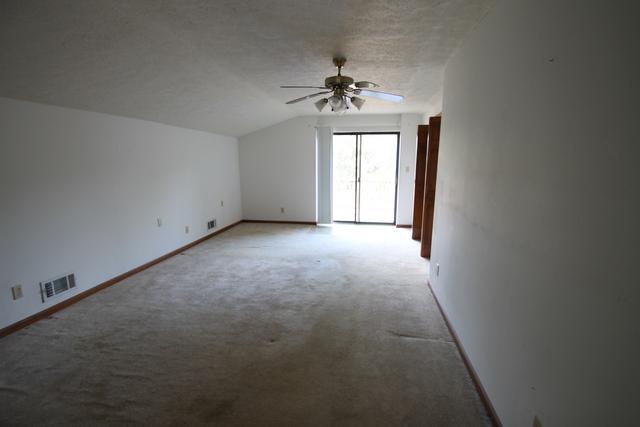 4189 Painter Branch Road Crestview, FL 32539 - Photo 18 of 35 an empty room with chandelier fan and windows