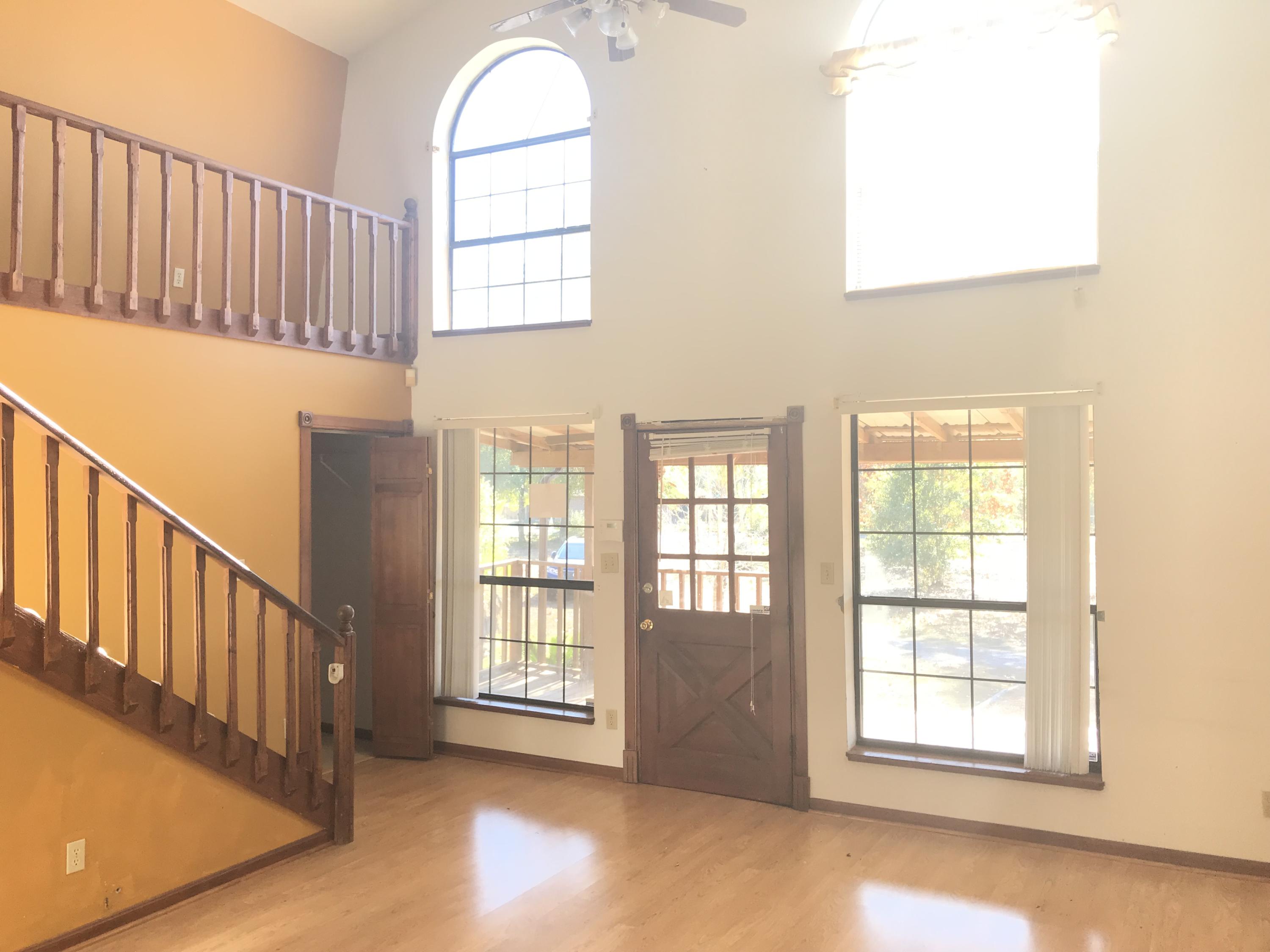 4189 Painter Branch Road Crestview, FL 32539 - Photo 2 of 35 an empty room with wooden floor and windows