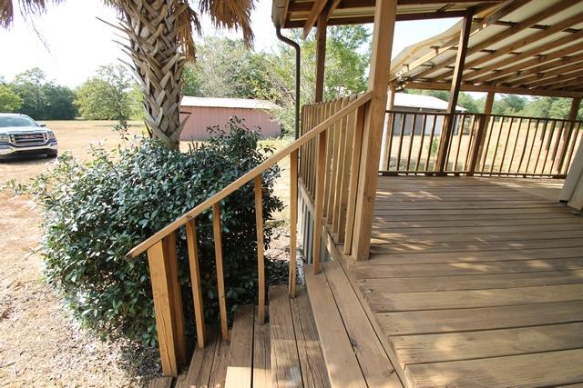 4189 Painter Branch Road Crestview, FL 32539 - Photo 21 of 35 a view of balcony with wooden floor and fence