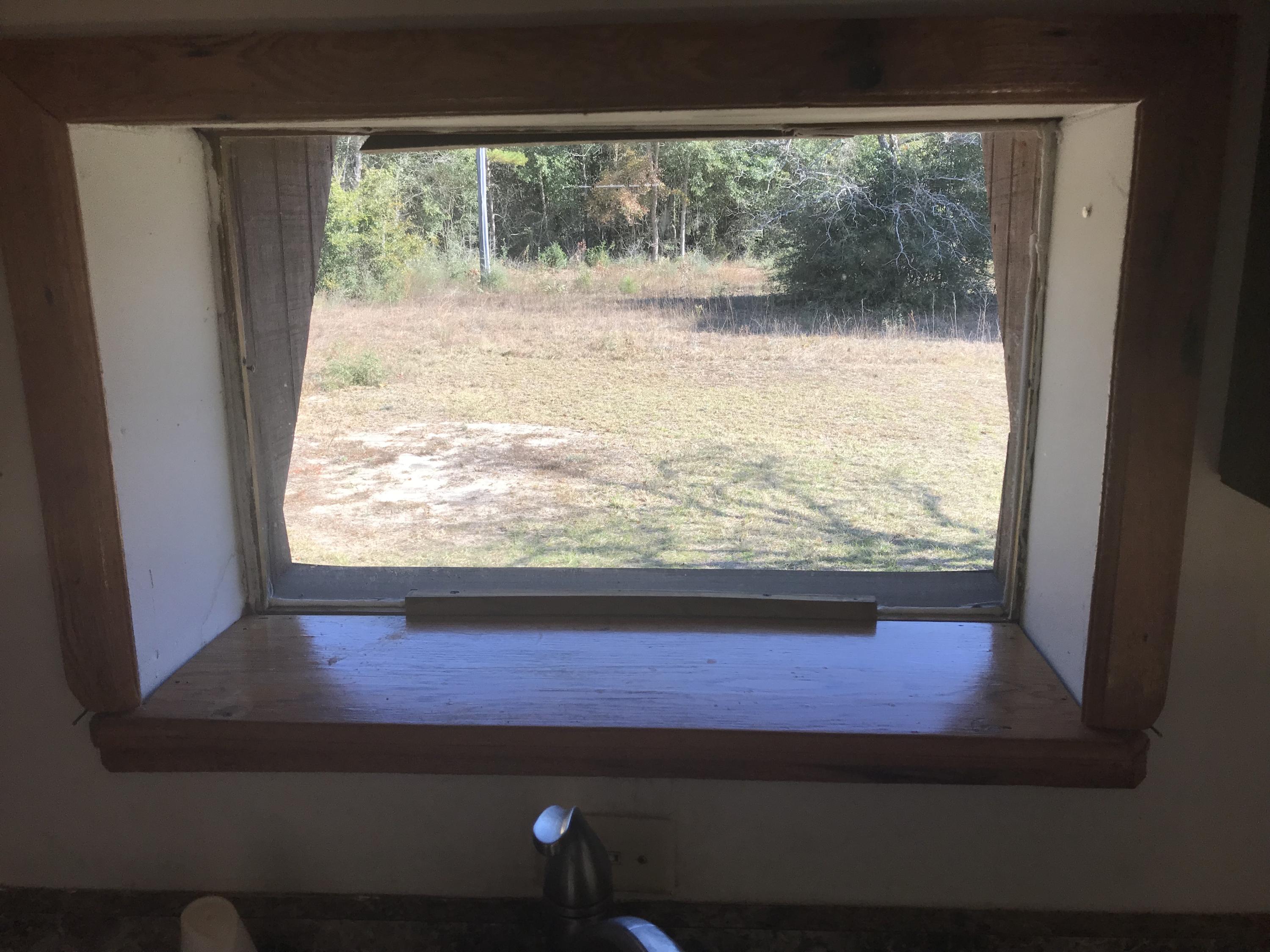 4189 Painter Branch Road Crestview, FL 32539 - Photo 6 of 35 a view of a glass door with a yard from a window