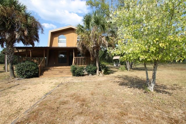 4189 Painter Branch Road Crestview, FL 32539 - Photo 9 of 35 a front view of a house with a yard and tree
