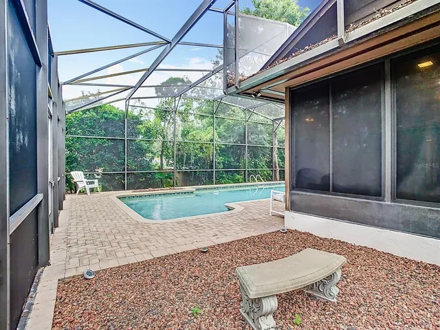 a view of a yard with plants and trees