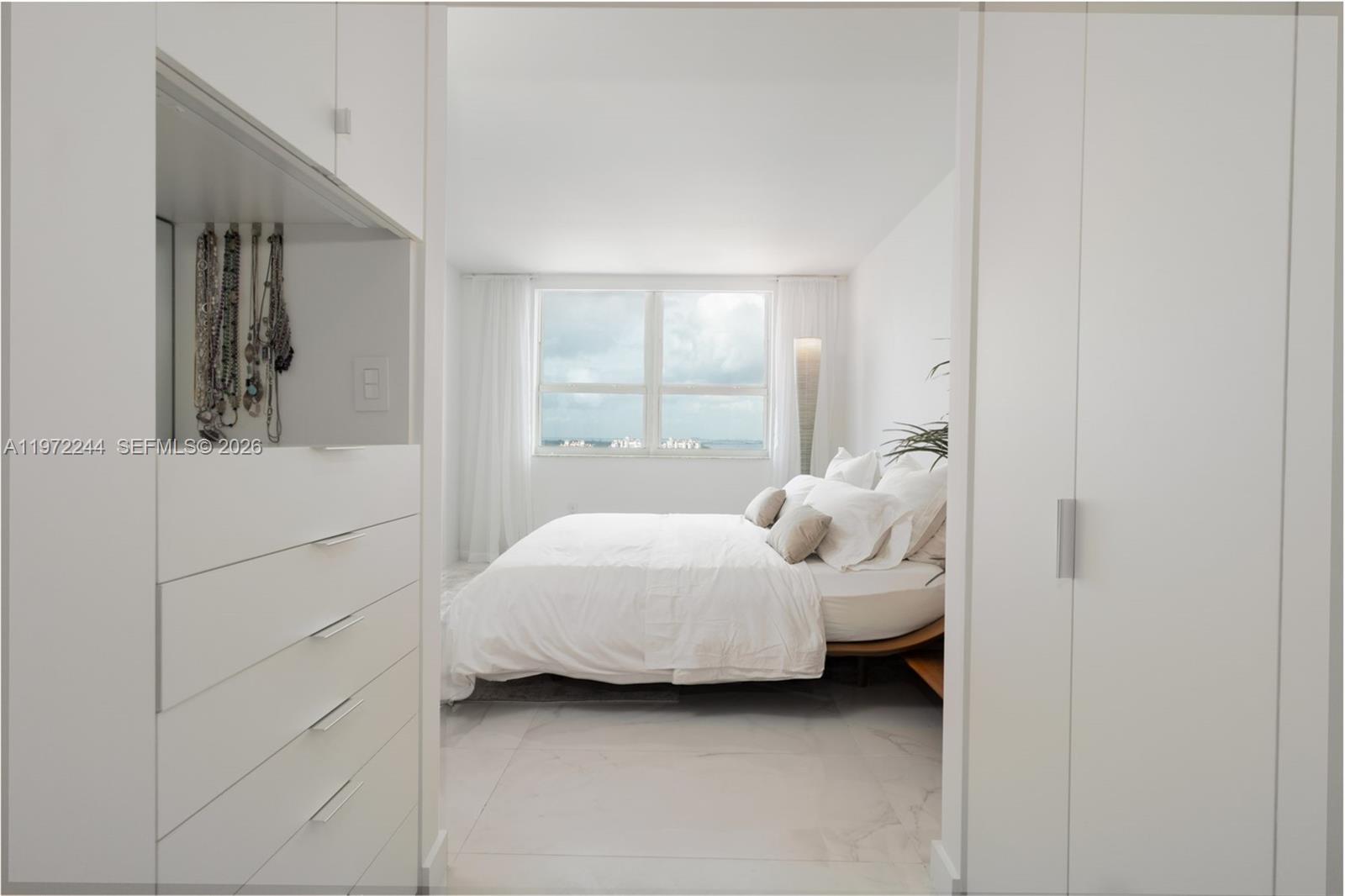90 Alton Road, Unit 1702 Miami Beach, FL 33139 - Photo 13 of 49 a bedroom with a bed and a window