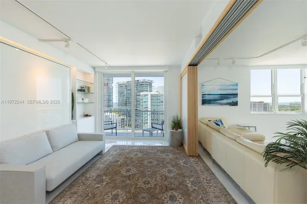 a living room with furniture and a large window