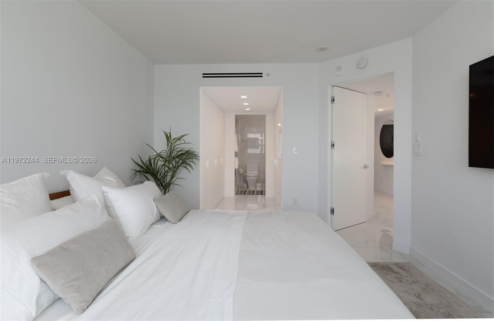 90 Alton Road, Unit 1702 Miami Beach, FL 33139 - Photo 17 of 49 a view of a white bath tub sitting in a bathroom