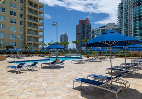 a swimming pool with outdoor seating and city view