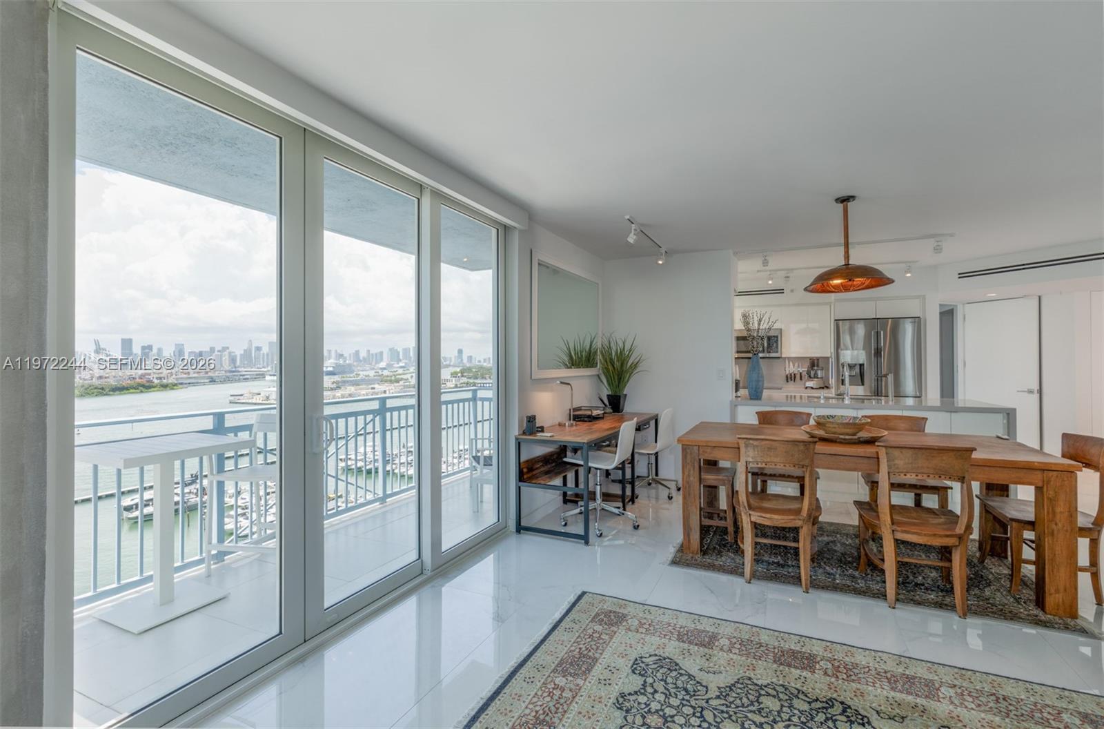 90 Alton Road, Unit 1702 Miami Beach, FL 33139 - Photo 3 of 49 a dining hall with furniture window and outside view