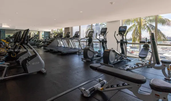a room with gym equipment and a large window