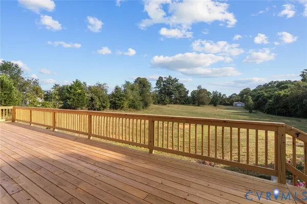 a view of balcony with wooden floor and fence