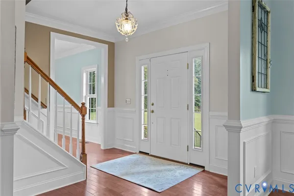 a view of an entryway with wooden floor and stairs
