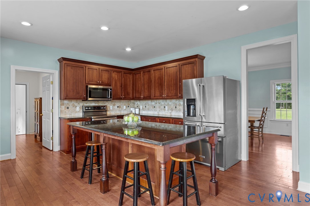 16431 River Road Chesterfield, VA 23838 - Photo 10 of 28 a kitchen with stainless steel appliances granite countertop a refrigerator a stove top oven a sink dishwasher and white cabinets with wooden floor