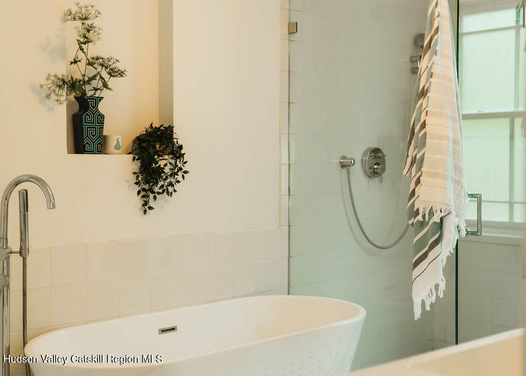675 Cooper Lake Road Woodstock, NY 12448 - Photo 13 of 31 a bathroom with a bathtub a sink and a shower